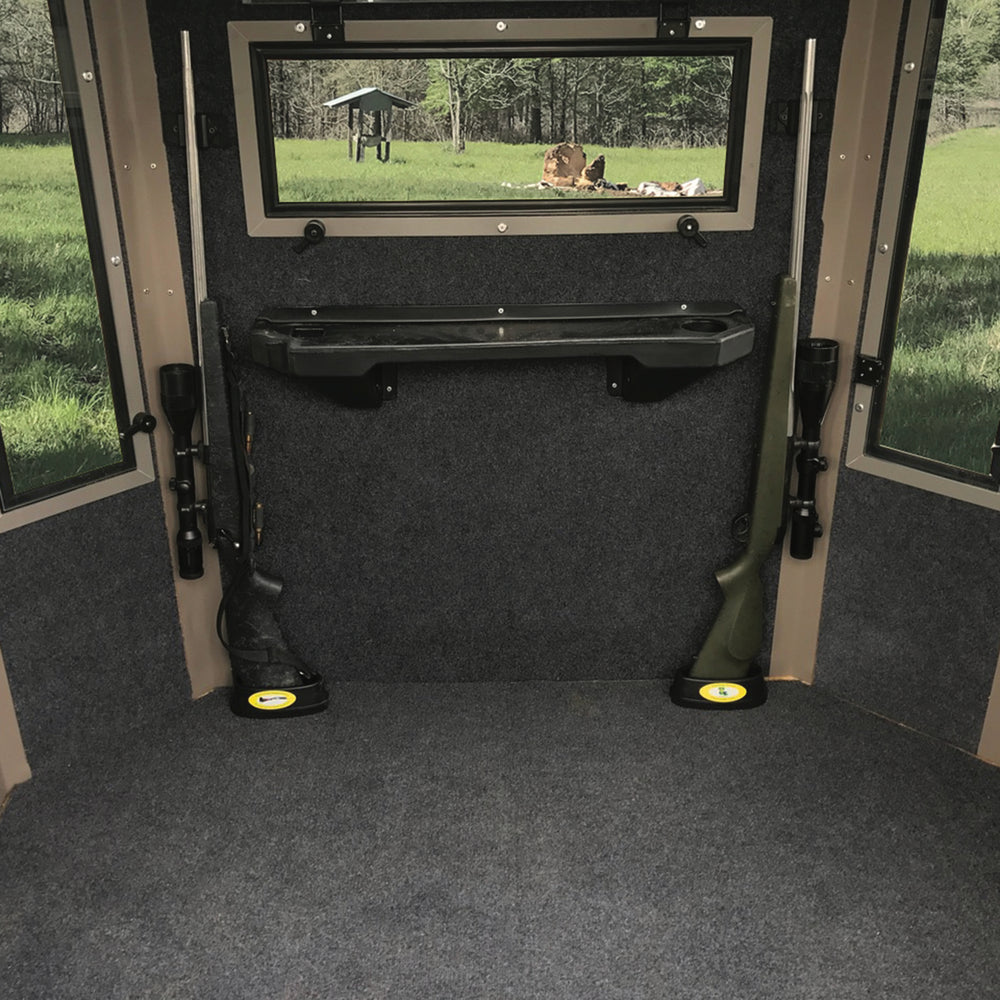 two rifles held in place with a CoJo gun magnet on the barrel and  each of the rifles are setting the butt of the guns in the cojo  Assperatus