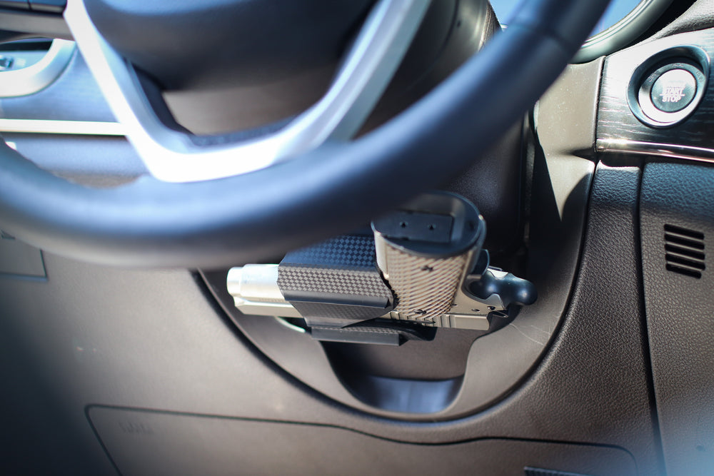 Universal gun holster mounted under the steering wheel.