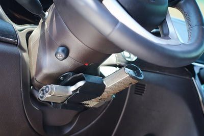Universal holster mounted under steering wheel