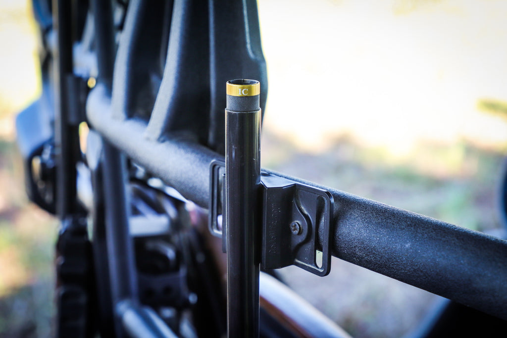 CoJo gun magnet holding the barrel of a shotgun in a UTV