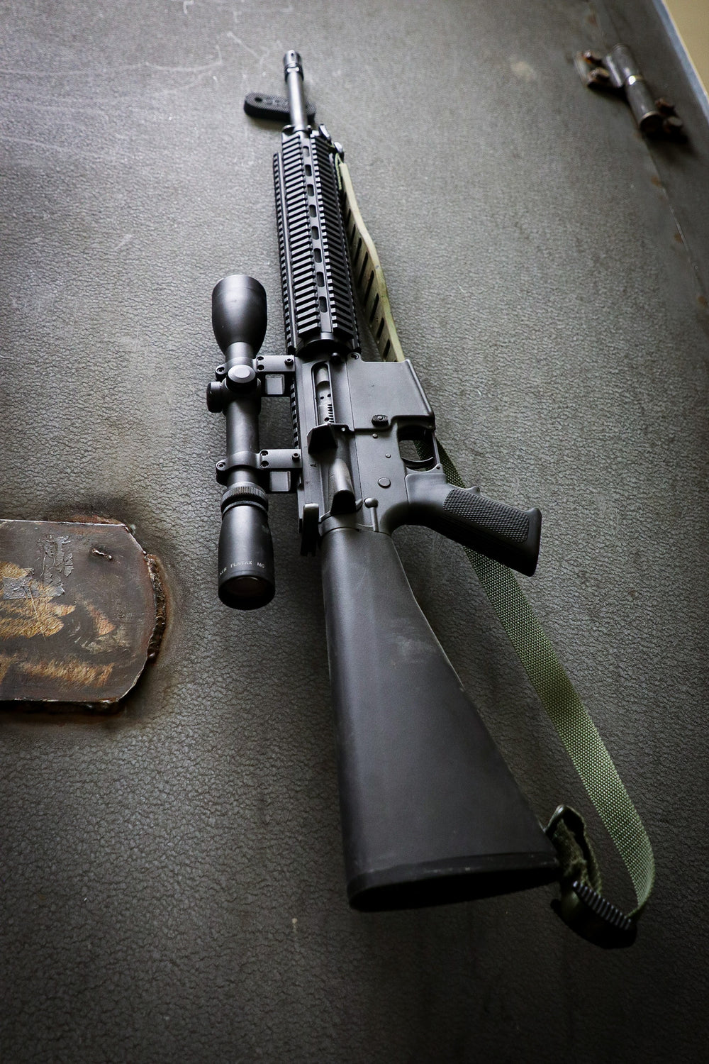 AR rifle being held by a CoJo Gun gripper on the wall of a safe.