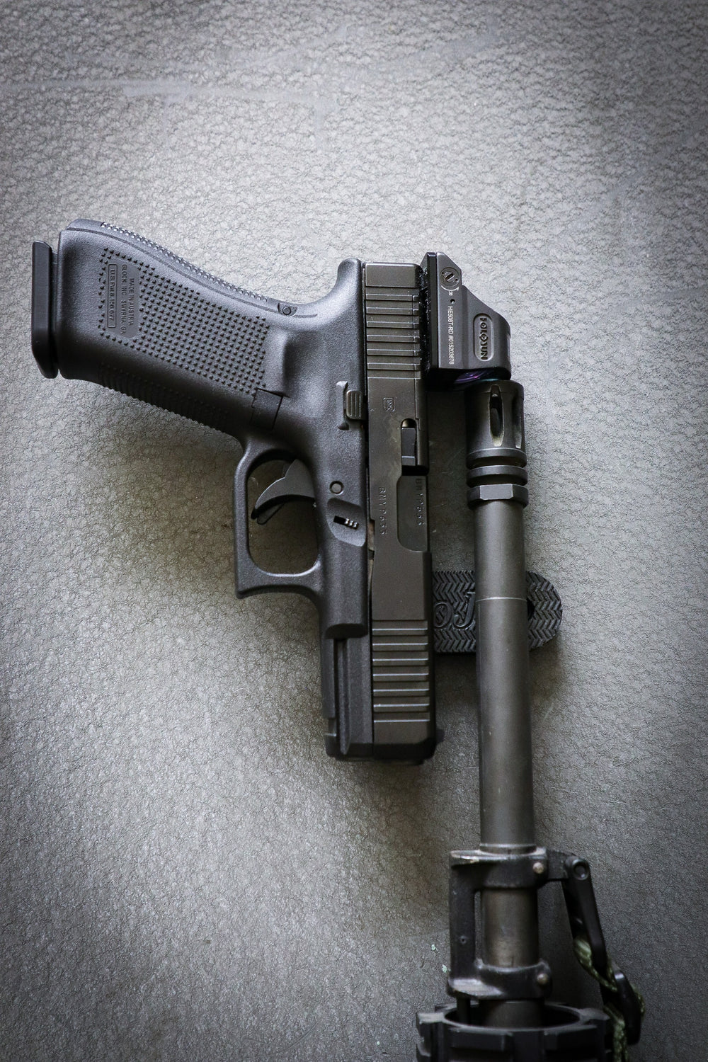 Pistol and a AR rifle held by a gun gripper gun magnet on a safe door